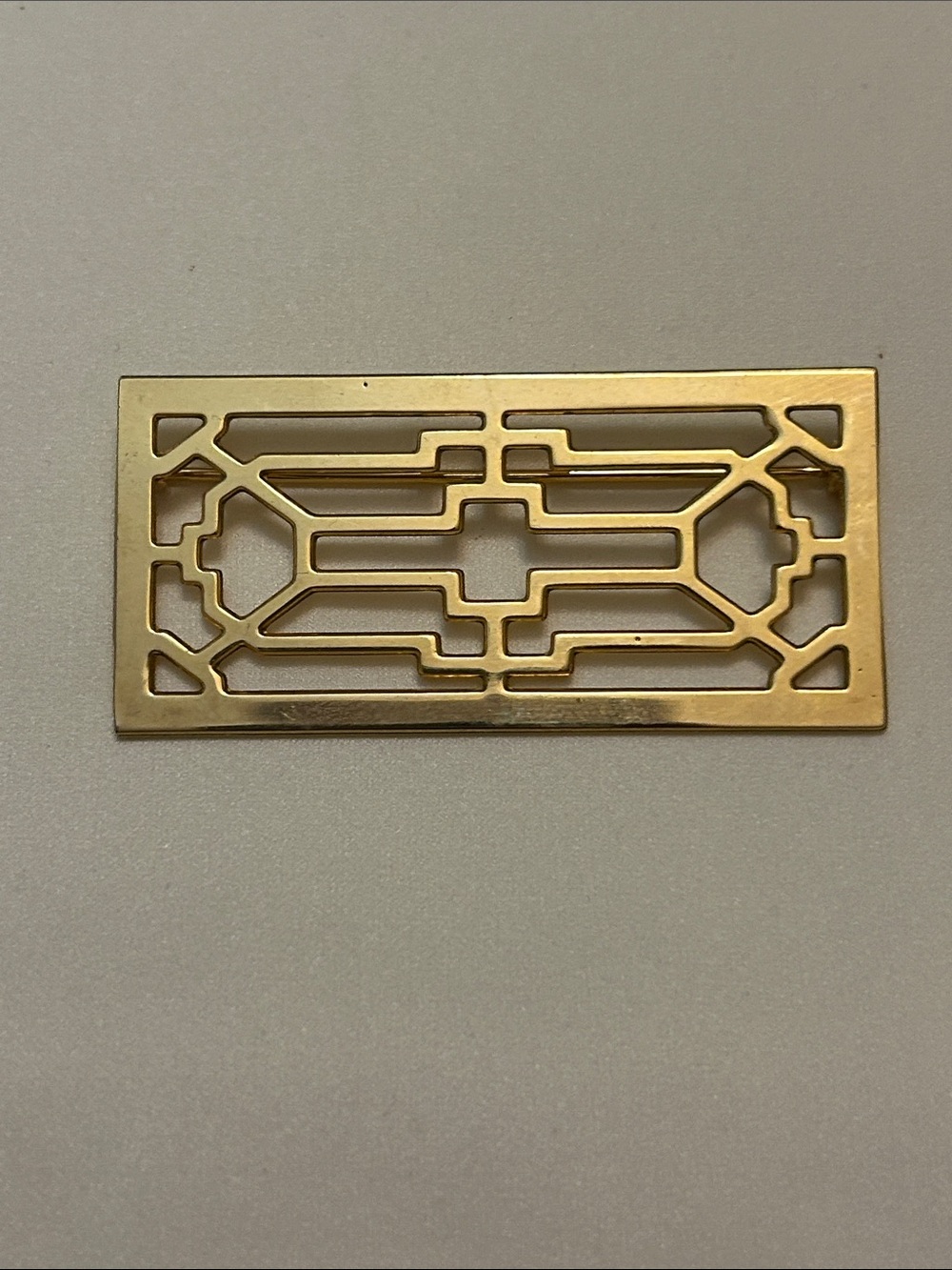 Elegant Gold Metal Brooch with Geometric Cutout Design